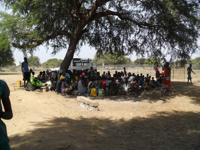 Patients waiting in the shade for clinic to start